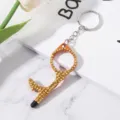 Detail view of orange rhinestone-encrusted no-touch door opener tool keychain with stylus tip - Orange