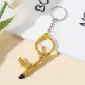 Detail view of yellow double-sided rhinestone encrusted door opener keychain with stylus tip - Yellow