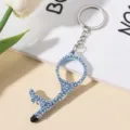Detail of blue rhinestone-encrusted door opener keychain with touch screen stylus tip - Light Blue