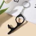 Close-up detail of black rhinestone-encrusted no-touch door opener tool. - Black