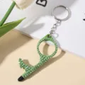 Detailed view of the green rhinestone-encrusted no-touch door opener tool keychain. - Green