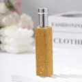 Detail of a 10ml portable perfume spray bottle covered in sparkling gold rhinestones - 10ml / Yellow