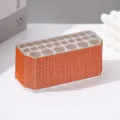 Detailed macro view of 26-slot acrylic makeup brush holder with orange rhinestone finish - Orange Red