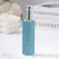 Close-up of a 10ml glass spray bottle featuring light blue rhinestones and silver cap. - 10ml / Sky Blue