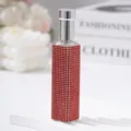Macro view of red rhinestone-encrusted 10ml portable perfume spray bottle. - 10ml / Red