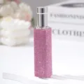 Close-up of a 10ml portable perfume spray bottle decorated with pink rhinestones - 10ml / Pink