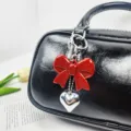 Elegant red acrylic bow keychain with silver heart pendant charm for black leather bags - Vertical Bow Pendant (02) / Red