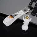 Cute astronaut keychain with white silicone strap and electroplated gold visor doll pendant. - Style C with Strap / Gold