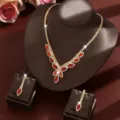 Elegant bridal jewelry set featuring a gold necklace and red marquise gemstone earrings - Two-Piece Set / Red
