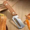 Stainless steel multi-functional fruit and vegetable peeler with wooden handle detail view. - Solid Wood Handle [Toothless Version]