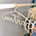 White plastic wavy hanger with multiple hooks for home dorm storage and organizing camisoles. - White