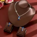 Detailed view of the blue crystal flower and teardrop necklace and earrings set closeup. - Two-Piece Set / Blue