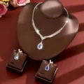 Close-up of bridal rhinestone necklace and earrings set with blue teardrop gemstone detail. - Two-Piece Set / Blue