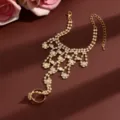 Closeup view of the sparkly rhinestone slave bracelet detail, elegant hand chain design. - HB991 / Gold