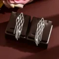 Detailed view of the luxury diamond rhinestone long tassel earrings with geometric diamond design. - Silver