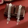 Sparkling rhinestone long tassel earrings featuring crystal diamonds and bow design for women. - Silver