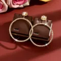 Luxury rhinestone hoop earrings with sparkling flower studs, elegant jewelry detail shot. - Gold
