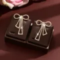 Rhinestone bow tassel earrings detail, elegant sparkling crystal design for daily fashion wear. - Gold