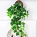 Realistic artificial hanging pothos vine with dense green leaves in a woven basket decor - Scindapsus Leaf