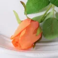 Detailed view of an orange artificial rose bud for wedding and home decoration - Lover's Bud / Orange