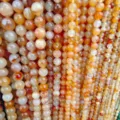 Detail view of colorful natural striped agate round beads strands for DIY jewelry making. - 4mm / Light Red Striped Agate