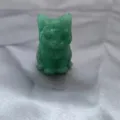 Close-up detail of the green crystal cat carving sculpture showing fine polished gemstone texture. - Green Aventurine