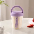 Portable clear plastic fruit salad cup with handle and fork for office and travel use. - Purple and White