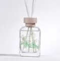 Difusor de aroma para el hogar con flores verdes decorativas en botella de cristal clara de 100ml. - Gardenia blanco puro