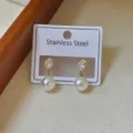 Elegant stainless steel earrings with cubic zirconia and white pearl drop studs. - Round Rhinestone Pearl Earrings