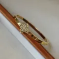Elegante bracciale in acciaio al titanio dorato con motivo a fiori di cristallo per lei - Stile Quadrifoglio Traforato Strass