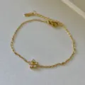 Elegant 18k gold plated stainless steel bracelet with a delicate crystal flower charm - 8mm Clear Flower Bracelet