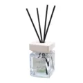 Aromatherapy diffuser bottle with black reeds and white square cap for home fragrance. - Clouds and Spring Trees