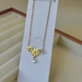 Elegant stainless steel daisy necklace with gold plating and zircon teardrop pendant. - Two Daisies Rhinestone Necklace