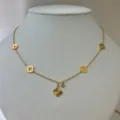 Elegant 18K gold plated stainless steel necklace featuring hollow clover charms and sunburst pendant - Hollow Clover Necklace