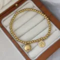 Goldenes 3mm Edelstahl Perlenarmband mit glücklichen Fu-Schriftzeichen-Anhängern - Doppeltes Glück und Freude Stil (16cm)