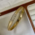 Elegant 18k gold plated stainless steel ribbed bangle with pave-set crystals - 7-Row Stones Style / Gold