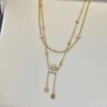 Elegant double-layer gold necklace featuring a crystal flower and teardrop pendants - Double Layer Rhinestone Flower Necklace / Gold