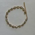 Elegant gold finish stainless steel bracelet featuring sparkling oval clear zircon links - Oval Rhinestone / White