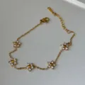 Elegant 18k gold plated stainless steel bracelet featuring five crystal flower charms - Bracelet with 5 Clear Flowers 8mm