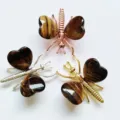 Natural stone butterfly and dragonfly ornament detail showing metal and crystal heart wings. - Gold / Tiger Eye Stone Bracelet