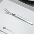 Stainless steel two-prong fruit fork, perfect for cakes and desserts, minimalist style. - Silver