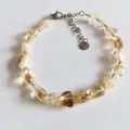 Detailed view of natural irregular crystal gemstone beaded bracelet with steel chain extension. - Yellow Crystal