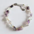 Natural irregular crystal gemstone bracelet detail shot featuring shiny gold spacer beads. - Fluorite