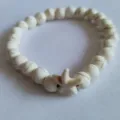 Detailed close-up showing texture of white stone beads and starfish charm on bracelet - White Starfish