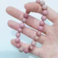 Natural stone pink beaded bracelet detail view, smooth polished gemstone single circle wrist jewelry. - Rhodochrosite