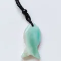 Natural crystal fish pendant necklace with black woven cord, elegant traditional style accessory. - Amazonite