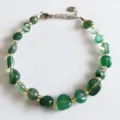 Natural irregular green crystal gemstone bracelet featuring gold beads and silver clasp - Green Agate