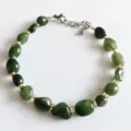 Natural irregular green crystal stone beaded bracelet with gold spacers and extension chain. - Xiuyan Jade