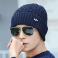 Close-up view of the cozy knitted winter beanie featuring textured pattern and metallic accent. - Blue