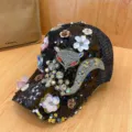 Detailed view of black sequin baseball cap featuring sparkling rhinestone fox and flower design. - Adjustable / Fox Black